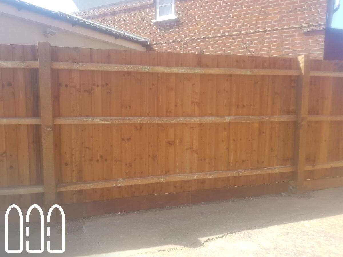 Feather edge fencing with wooden posts and gravel boards