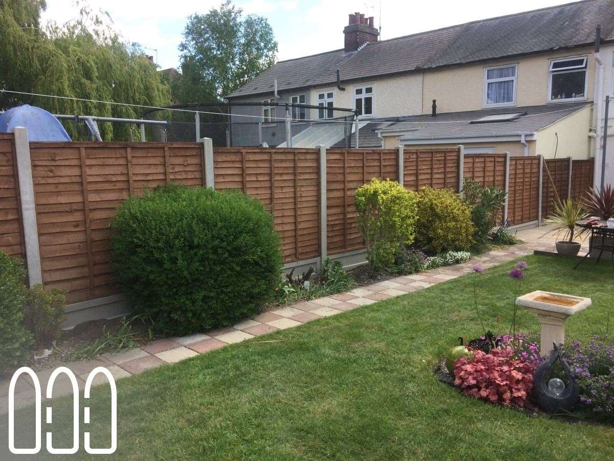 Waney fencing with concrete posts and gravel boards