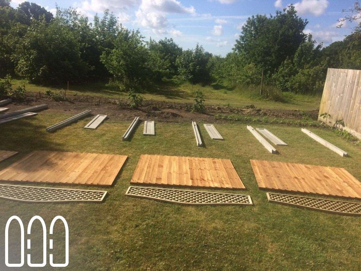 Close board fencing with concrete posts, gravel boards and a convex bow top diamond trellis