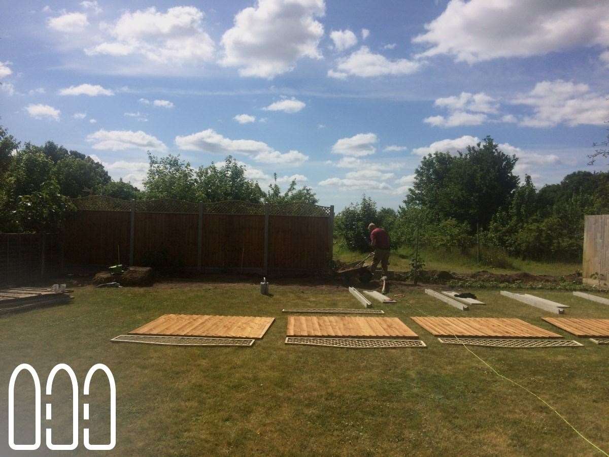 Close board fencing with concrete posts, gravel boards and a convex bow top diamond trellis