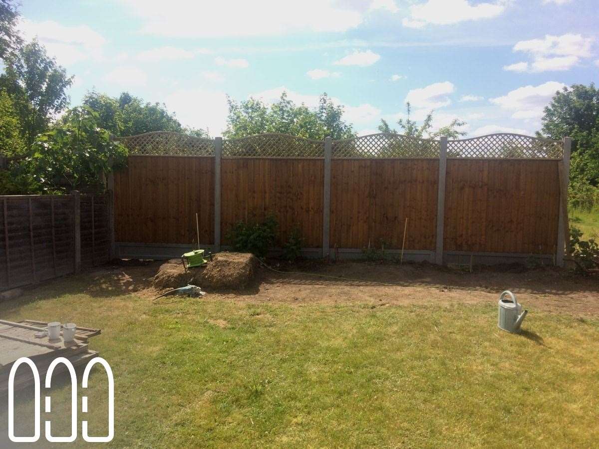 Close board fencing with concrete posts, gravel boards and a convex bow top diamond trellis