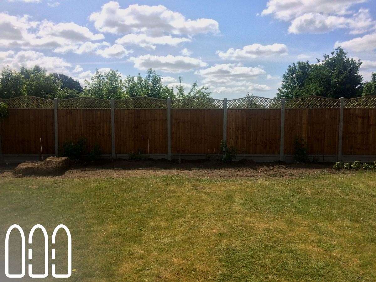 Close board fencing with concrete posts, gravel boards and a convex bow top diamond trellis