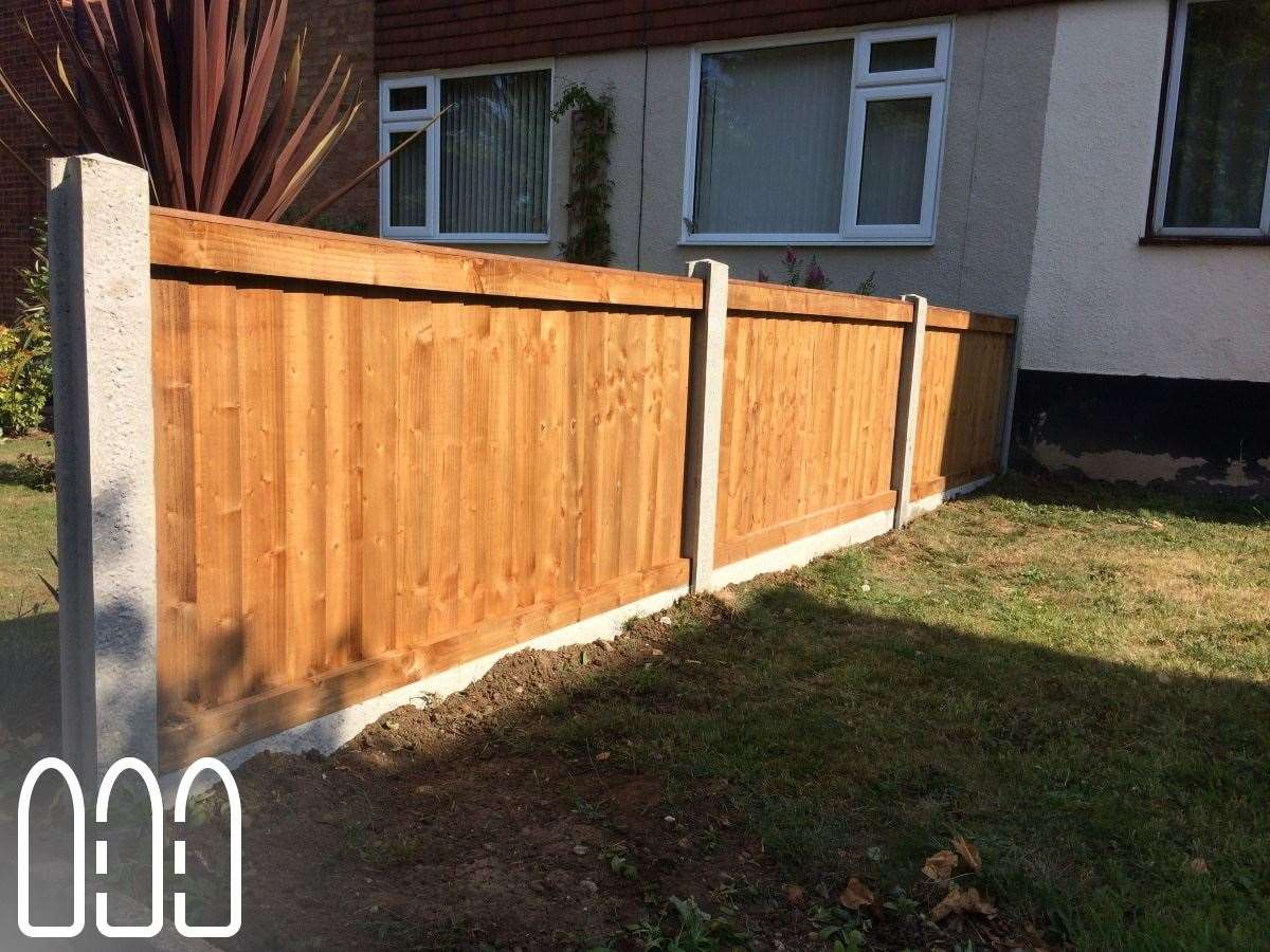 Close board fencing with concrete posts and gravel boards