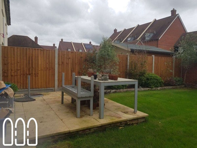 Close board fencing with wooden posts and gravel boards plus a new gate