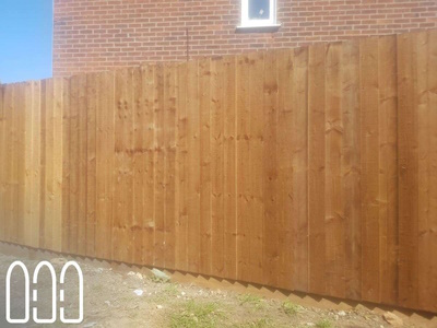 Feather edge fencing with wooden posts and gravel boards