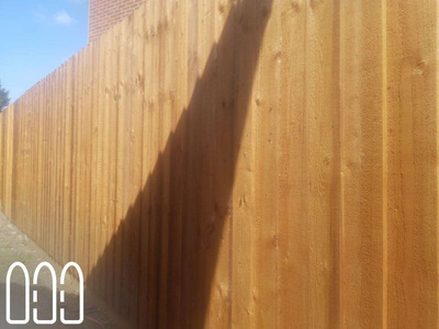 Feather edge fencing with wooden posts and gravel boards