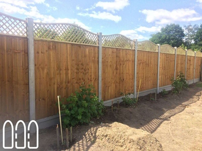 Close board fencing with concrete posts, gravel boards and a convex bow top diamond trellis